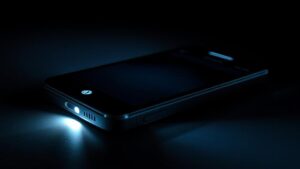 alt_text: Close-up of Droid Turbo with flashlight on, illuminating a dark, reflective environment.