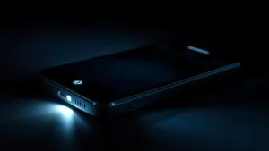 alt_text: Close-up of Droid Turbo with flashlight on, illuminating a dark, reflective environment.
